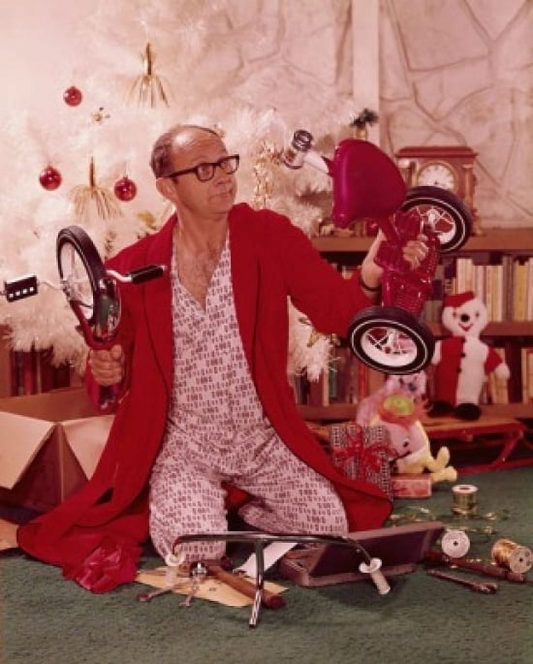 Mature man on his knees and holding parts of a tricycle Canvas Art - (24 x 36)