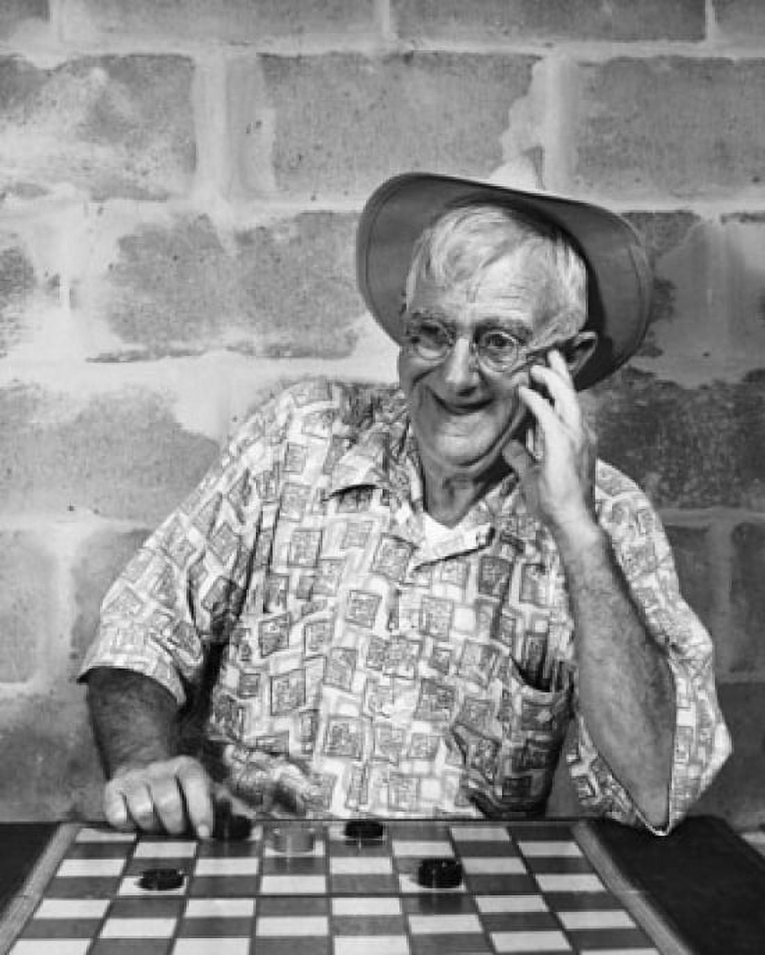 Mature man playing checkers and smiling Canvas Art - (18 x 24)