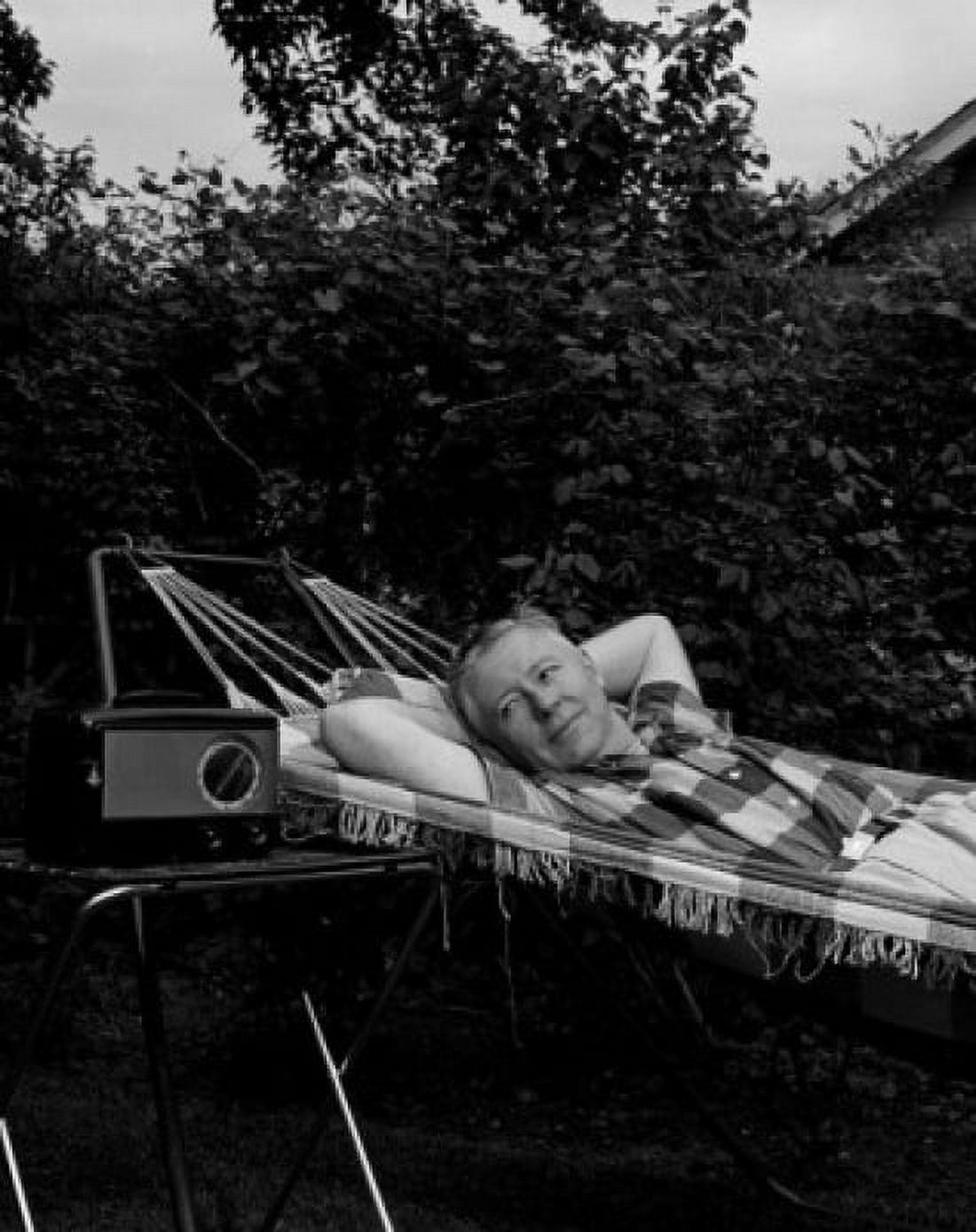 Mature man relaxing in hammock and listening radio Canvas Art - (18 x 24)