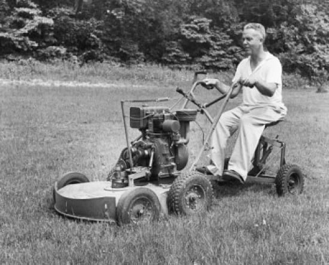 Mature man riding a mower in a garden Canvas Art - (24 x 36)