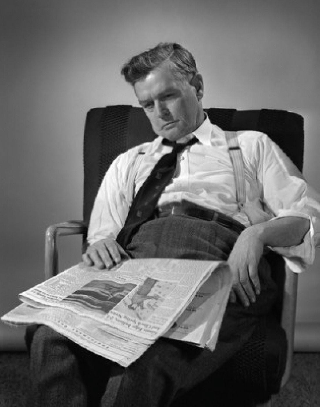 Mature man sitting on chair with newspaper Canvas Art - (18 x 24)