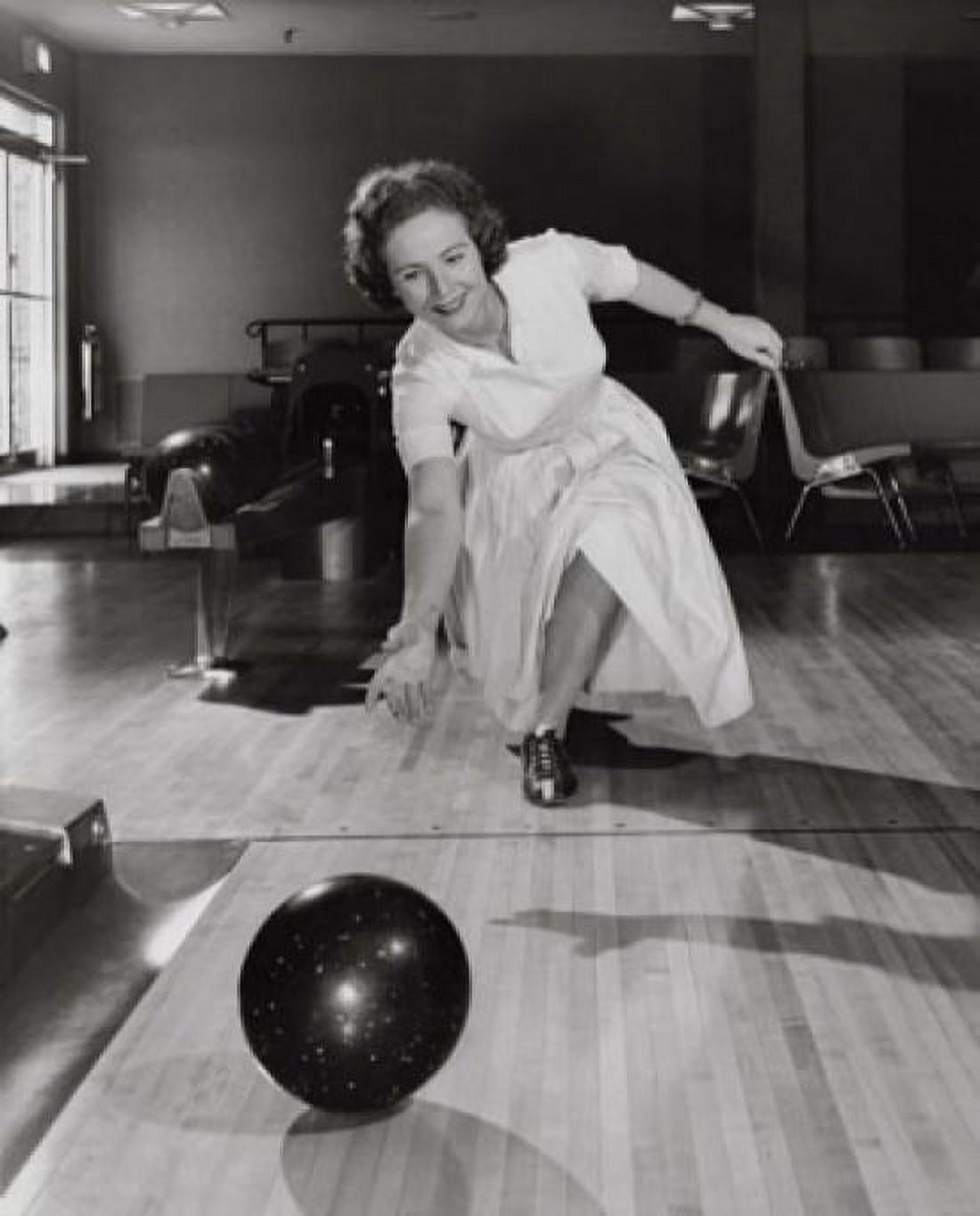 Mature woman bowling in a bowling alley Canvas Art - (24 x 36)
