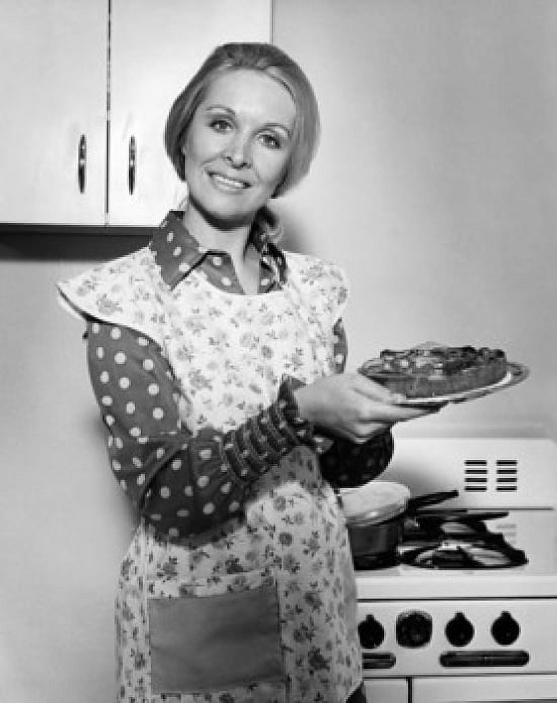 Mature woman holding a plate of food and smiling Canvas Art - (24 x 36)