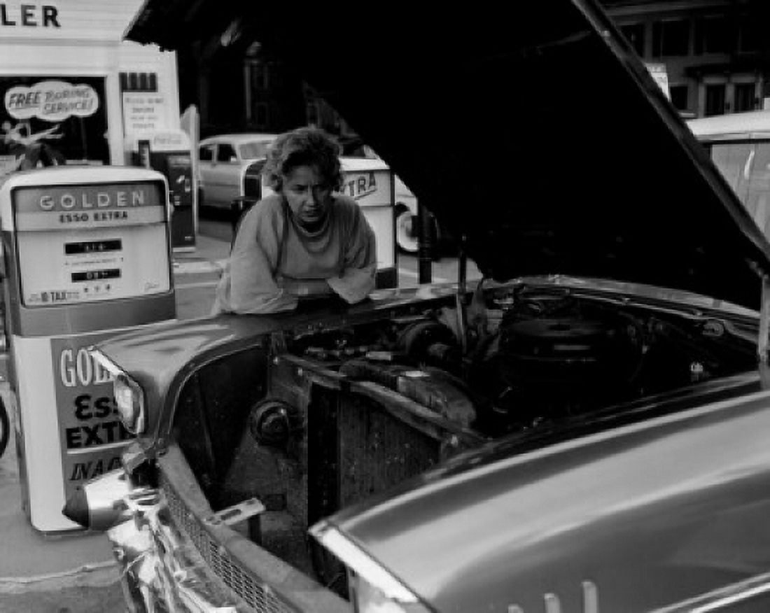 Mature woman leaning against car and looking at car engine Canvas Art - (18 x 24)