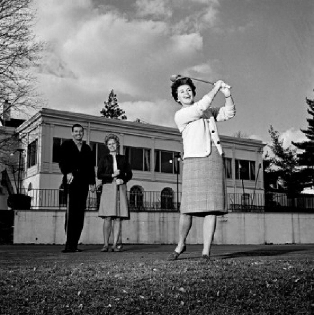Mature woman plying golf while pair of people is watching Canvas Art - (24 x 36)