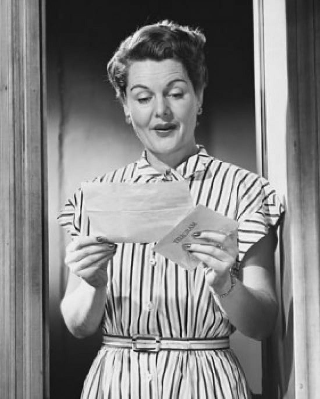 Mature woman reading a letter and smiling Canvas Art - (18 x 24)