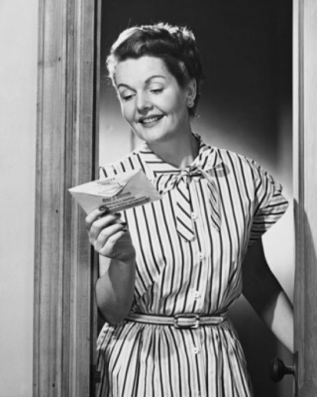 Mature woman reading a letter and smiling Canvas Art - (18 x 24)