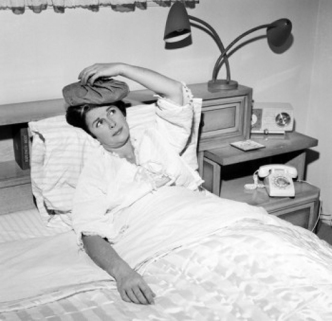 Mature woman reclining in bed with headache Canvas Art - (18 x 24)