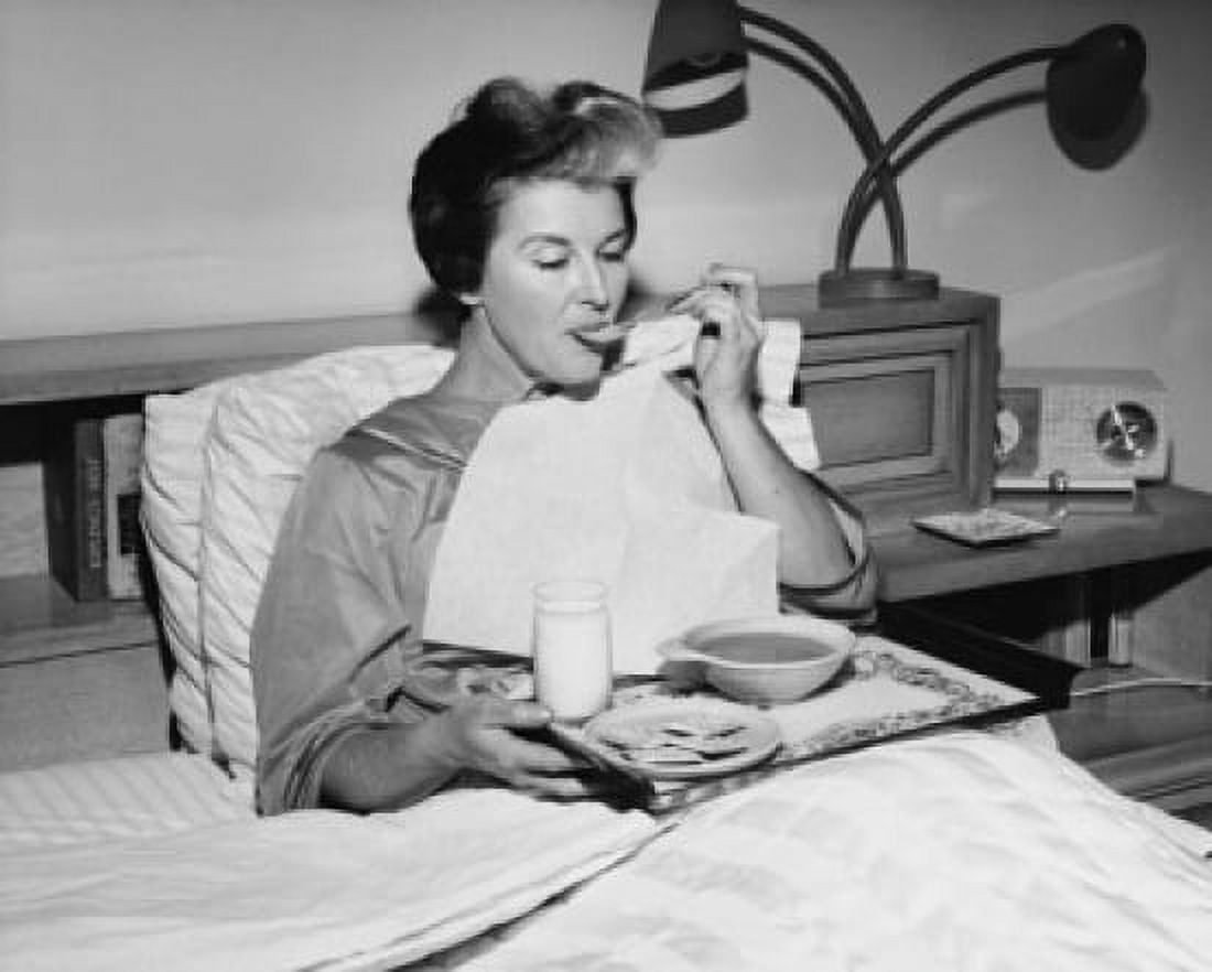 Mature woman reclining in the bed and eating soup Canvas Art -  (18 x 24)