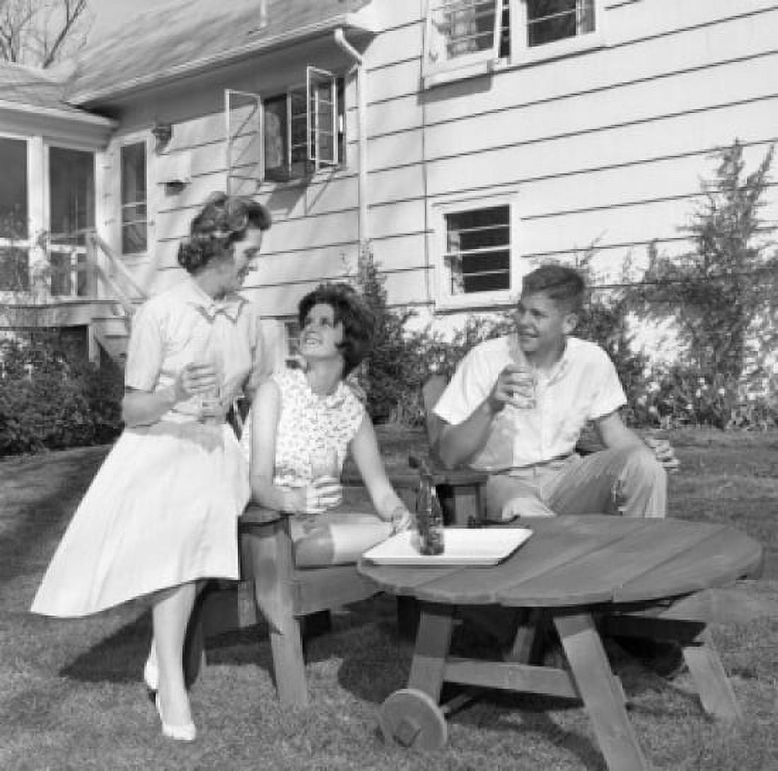 Mature woman with adult son and daughter sitting in backyard and drinking water Canvas Art - (18 x 24)