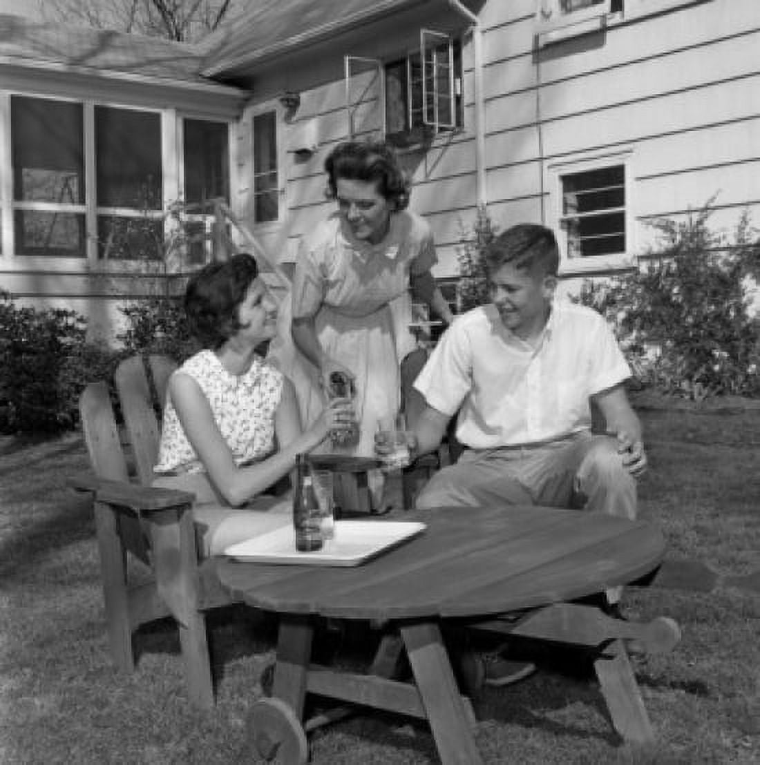 Mature woman with adult son and daughter sitting in backyard and drinking water Canvas Art - (24 x 36)