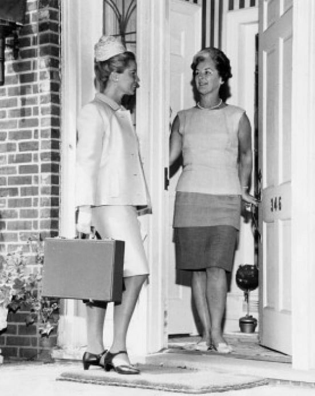 Mature women standing at a door and talking to a door to door salesperson Canvas Art - (24 x 36)