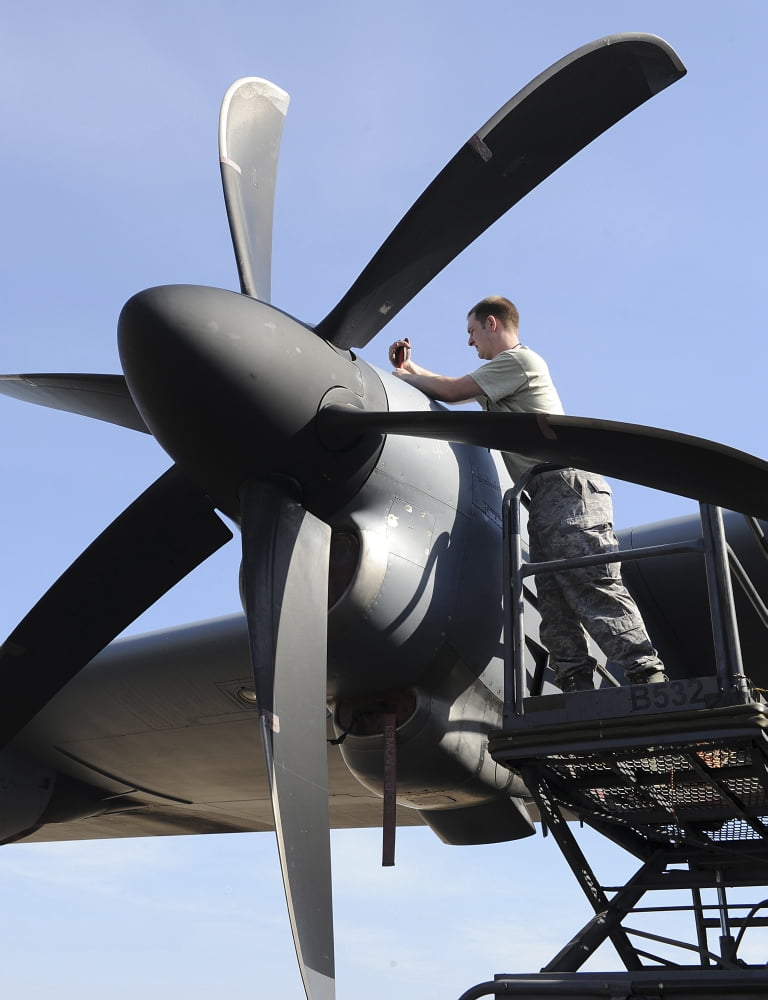 Mechanic finishes moving an engine propeller on a C-130J Super Hercules Canvas Art - Stocktrek Images (25 x 32)