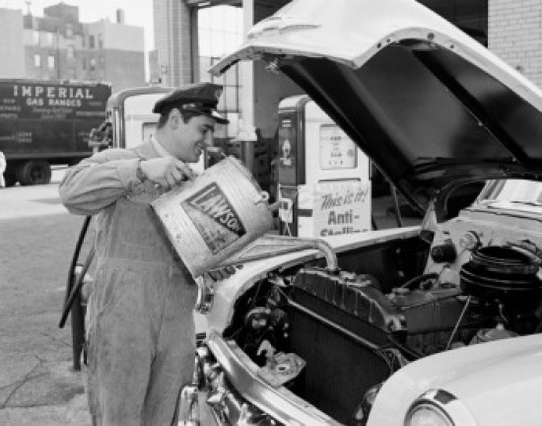 Mechanic pouring oil into car engine Canvas Art - (18 x 24)