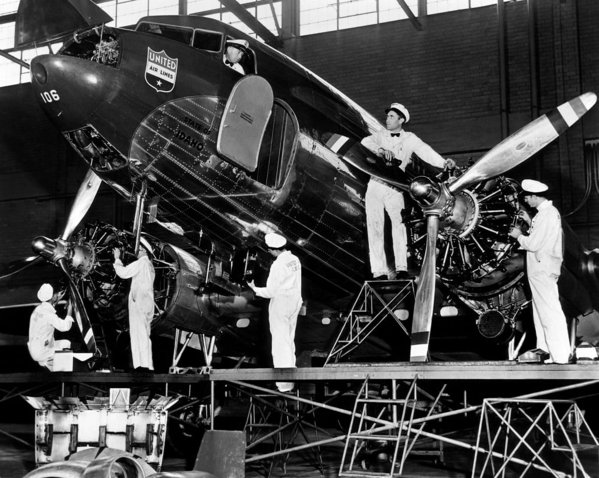 Mechanics Give A United Airline'S Mainliner Airplane A Routine Checkup