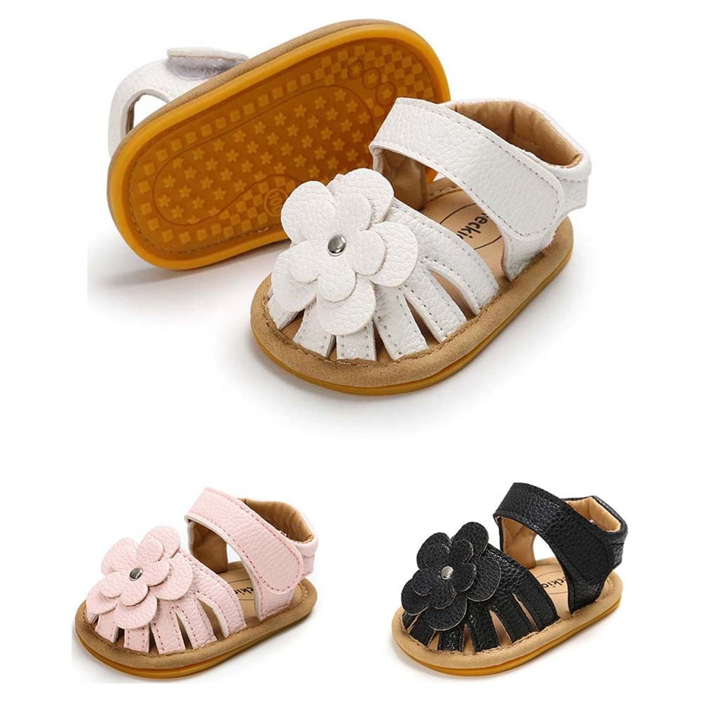 three colors of baby sandals with a flower on them