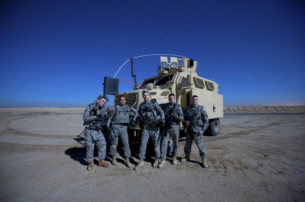 Medical personnel pose for a group photo around their MRAP vehicle Canvas Art - Terry MooreStocktrek Images (35 x 24)