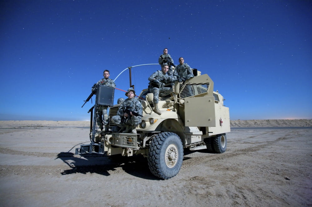Medical personnel pose for a group photo atop their MRAP vehicle Canvas Art - Terry MooreStocktrek Images (18 x 12)