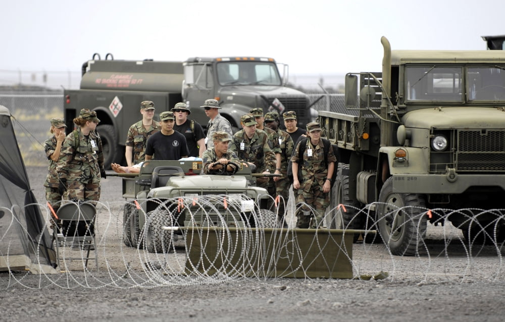 Medical personnel transport patients to a nearby clinic Canvas Art - Stocktrek Images (35 x 22)
