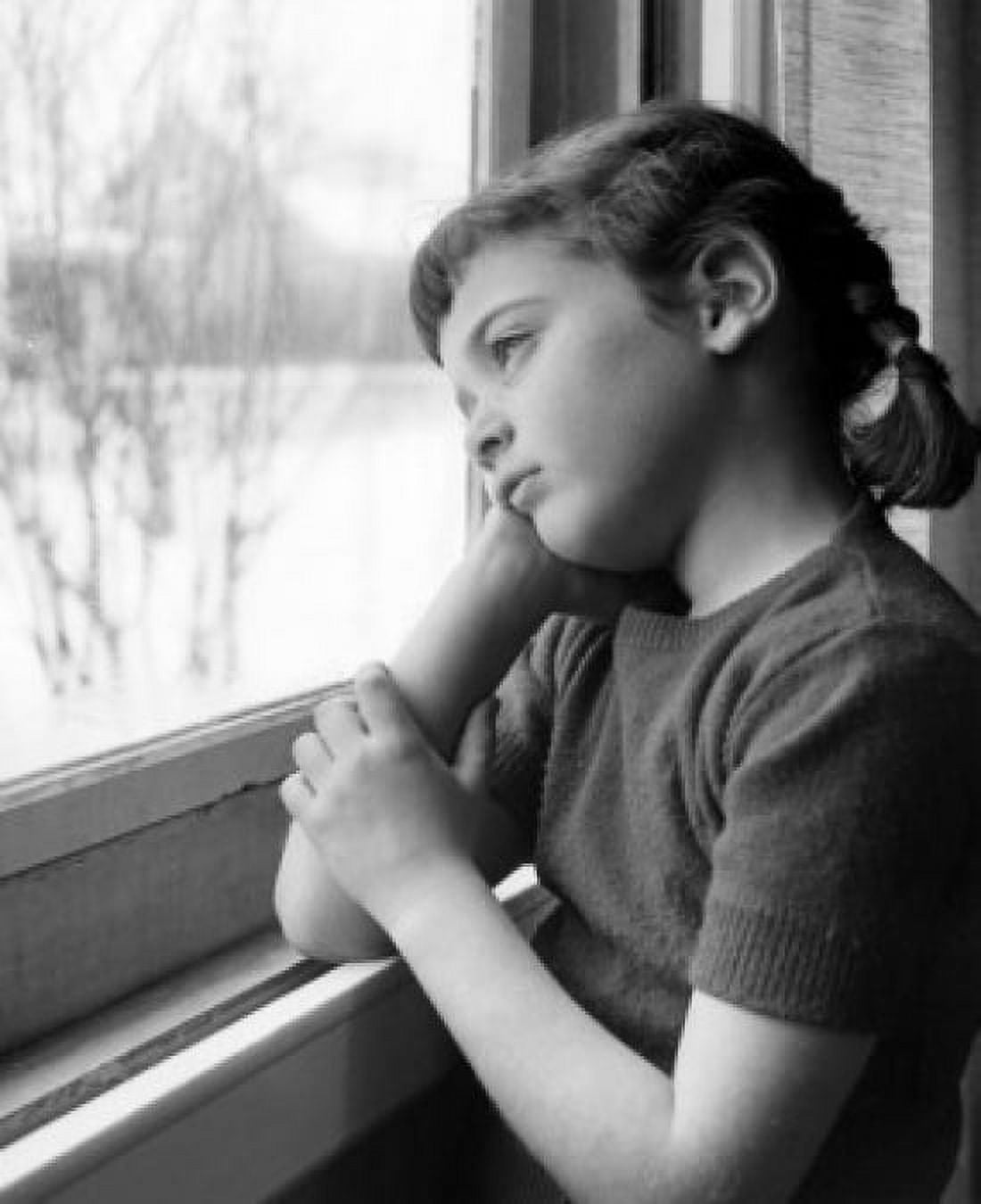 Melancholic girl looking through window Canvas Art - (24 x 36)