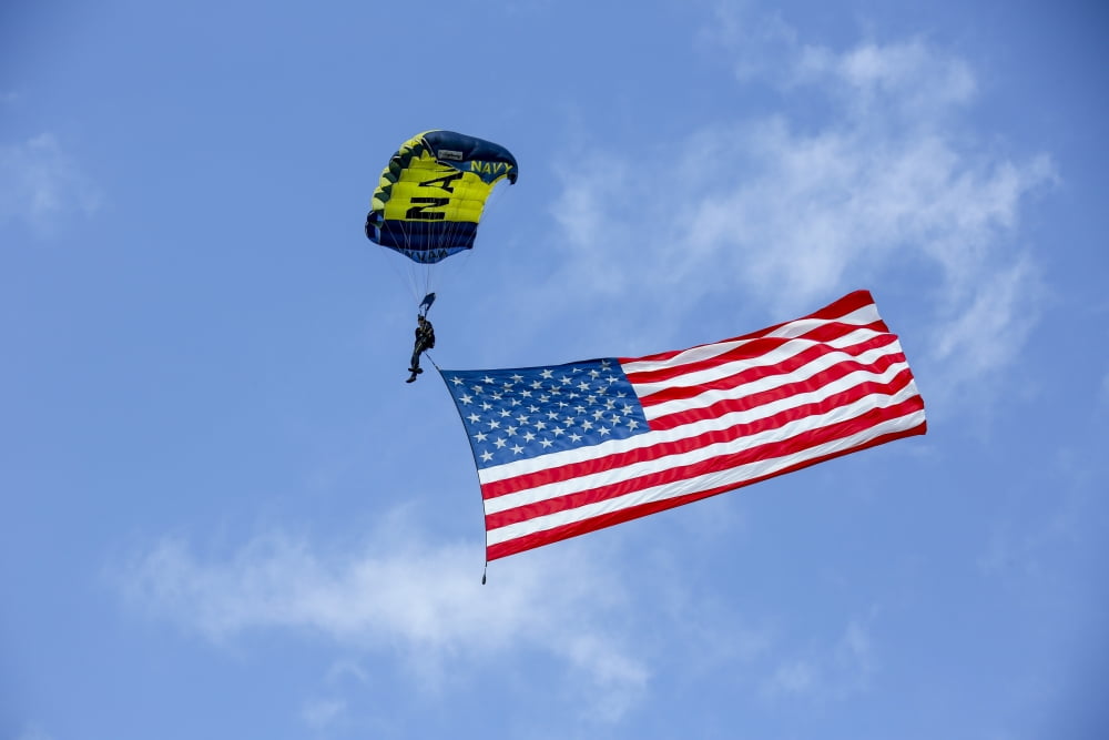Member of the US Navy Parachute Team flies the American Flag Canvas Art - Michael WoodStocktrek Images (17 x 12)