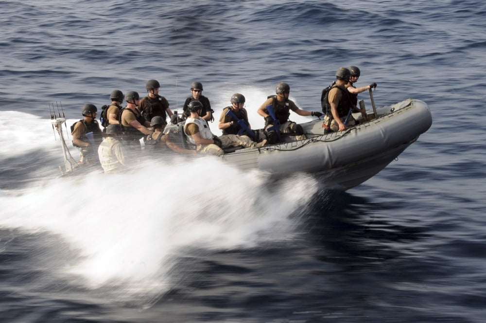 Members of a visit board search and seizure team maneuver in a rigid-hull inflatable boat Canvas Art - Stocktrek Images (35 x 23)