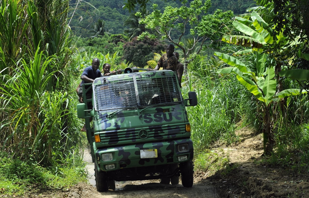 Members of the Royal St Lucia Police Forces Special Service Unit make their way through the jungle terrain Canvas Art - Stocktrek Images (35 x 23)