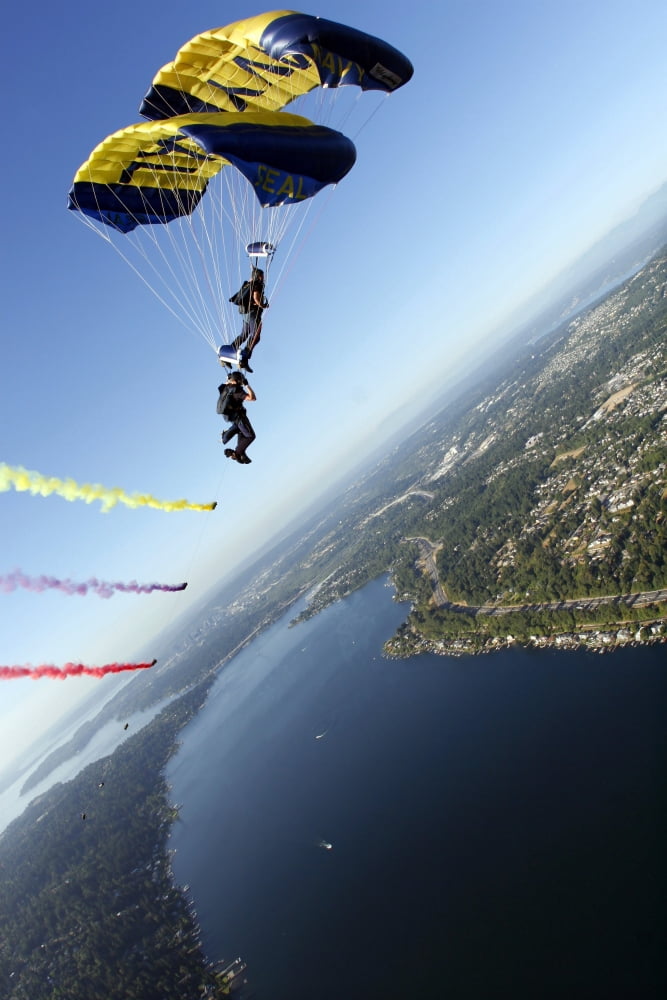 Members of the US Navy Parachute Team the Leap Frogs perform a bi-plane with their parachutes above Seattle Canvas Art - Stocktrek Images (23 x 34)