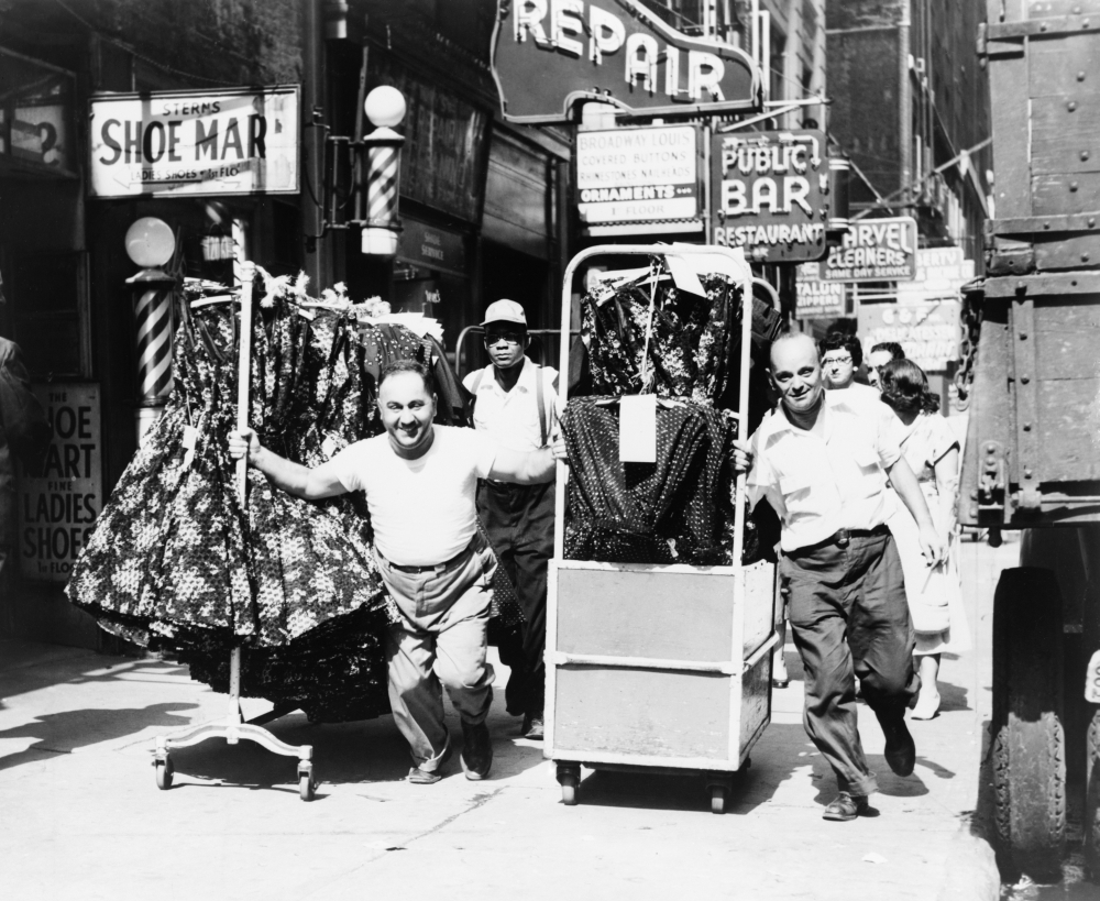 Men On Rack Men Pulling Racks Of Clothing On Busy Sidewalk In Garment District ...