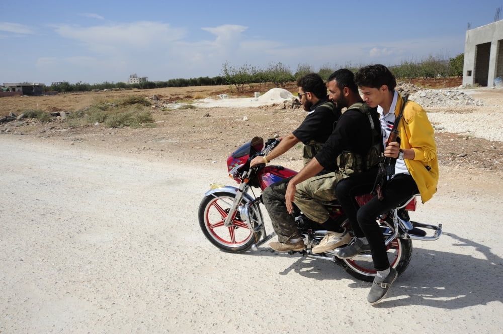 Men from the Free Syrian Army on a motorcycle in Azaz Syria Canvas Art - Andrew ChittockStocktrek Images (35 x 23)