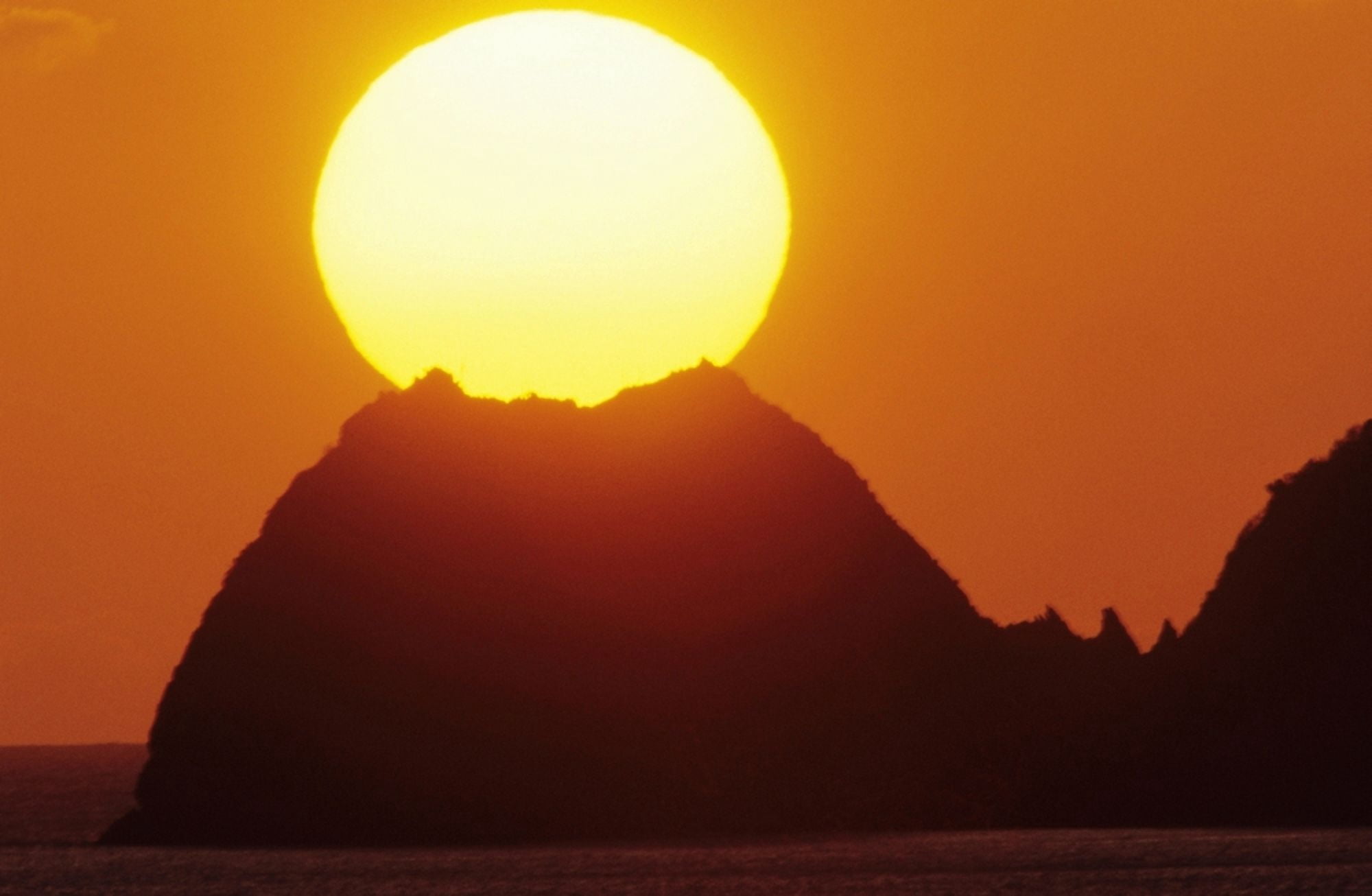Mexico Manzanillo Sun Setting In Orange Sky Over Ocean And Silhouetted Hill Canvas Art - Larry Dale Gordon Design Pics (34 x 22)