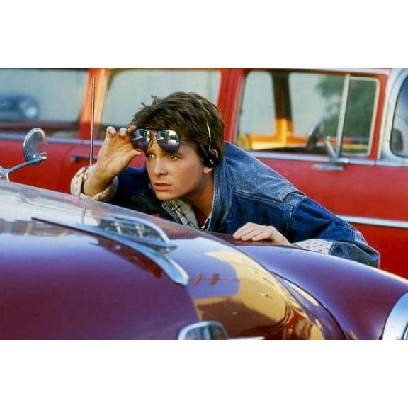 Michael J. Fox in Back to the Future with glasses in between two cars 24x36 Poster