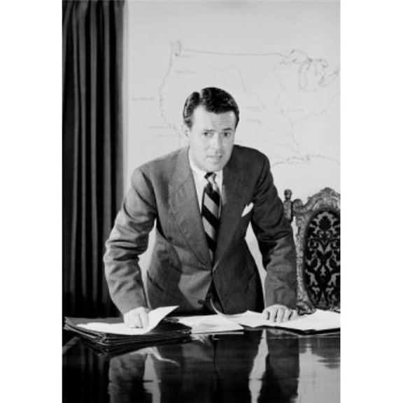 Mid Adult Man Leaning Against Desk in Office Poster Print - 18 x 24 in.