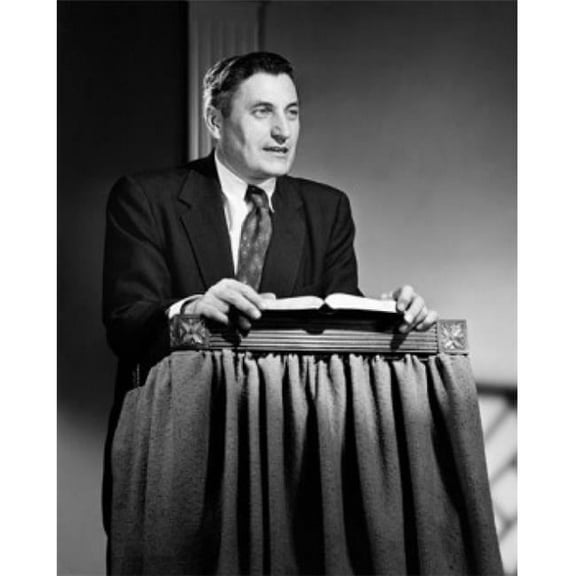 Mid Adult Man Standing at a Lectern & Talking Poster Print - 18 x 24 in.