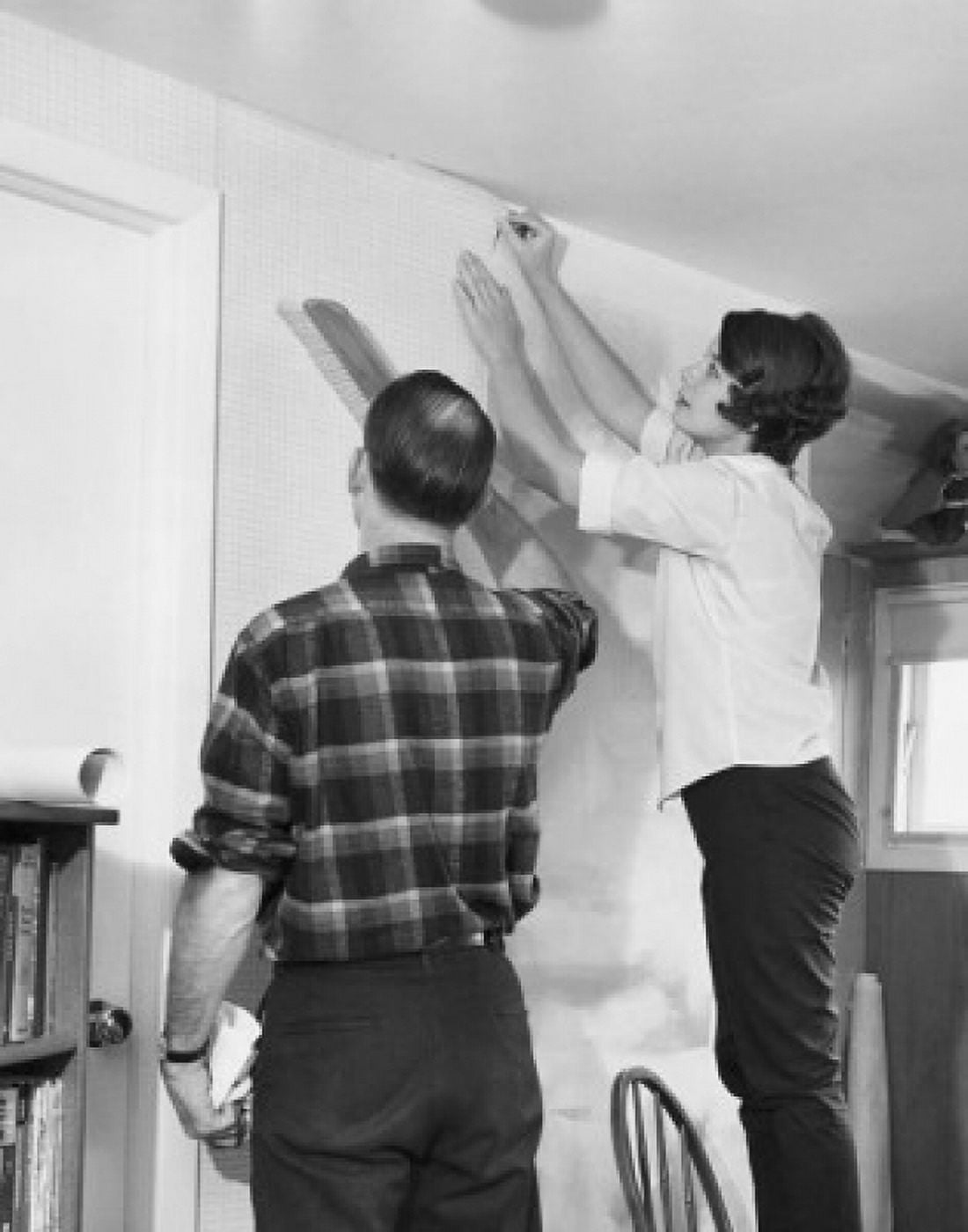 Mid adult couple applying wallpaper in a room Canvas Art - (18 x 24)