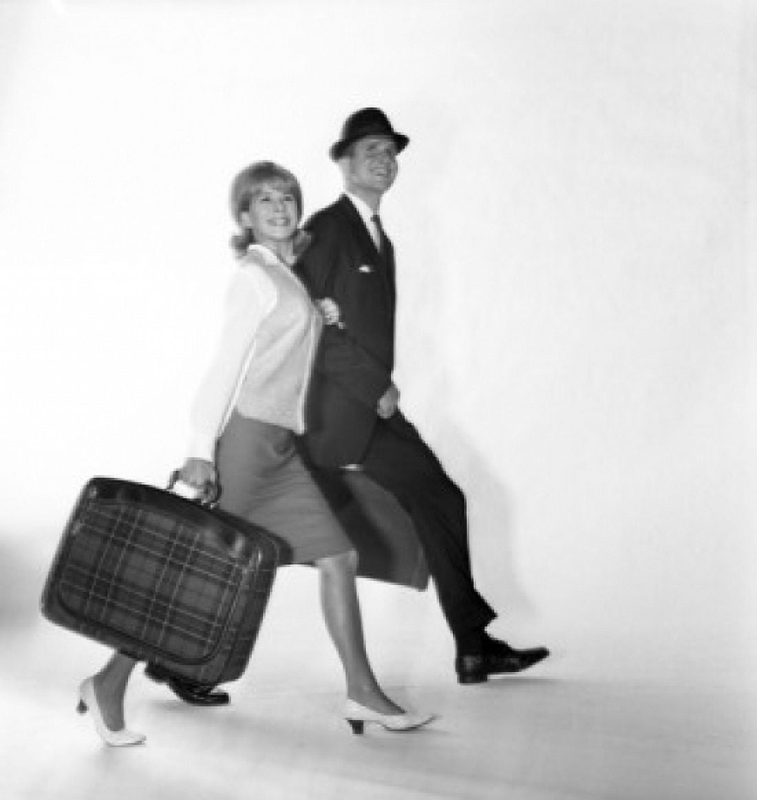 Mid adult couple carrying suitcases and smiling Canvas Art - (24 x 36)
