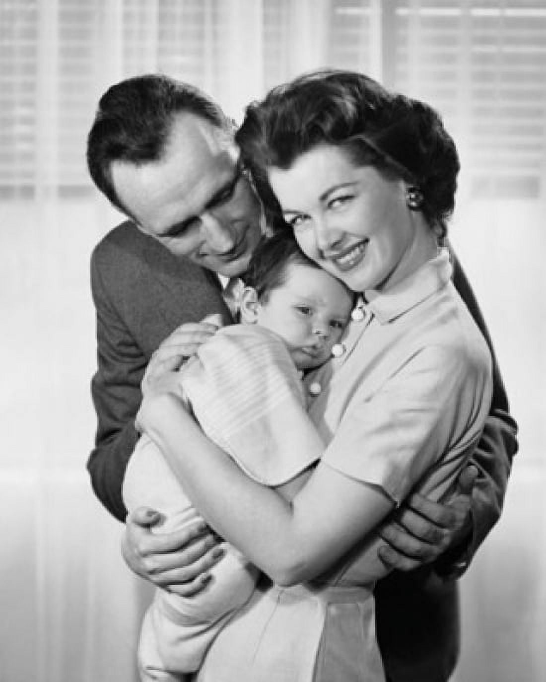 Mid adult couple holding baby and smiling Canvas Art - (18 x 24)