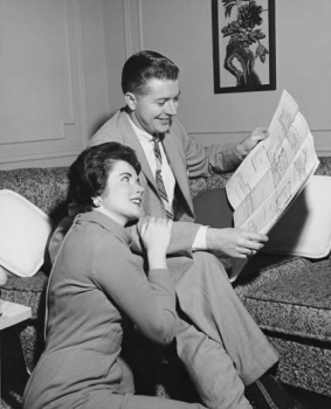 Mid adult couple looking at a blueprint and smiling Canvas Art - (18 x 24)