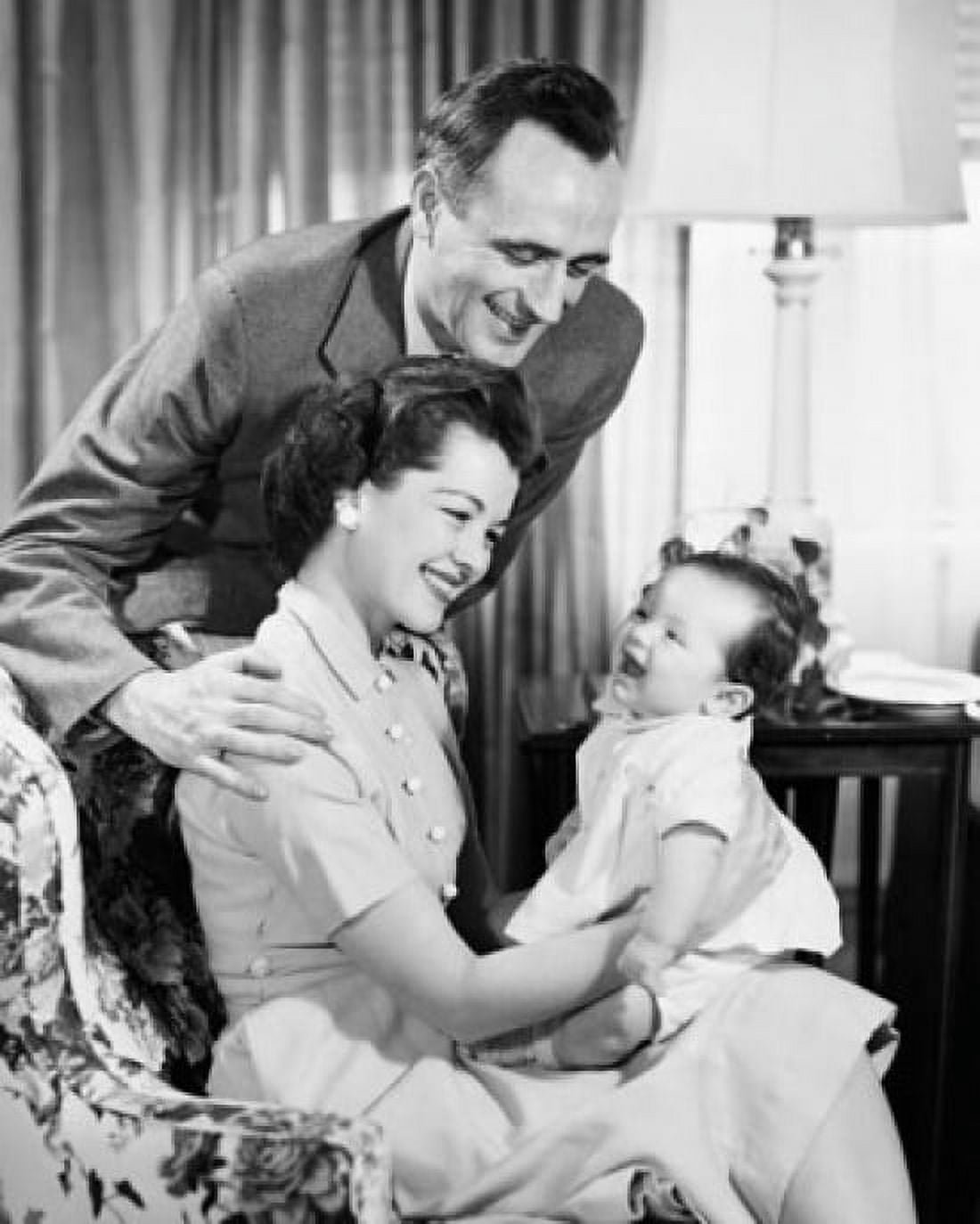 Mid adult couple looking at daughter and smiling Canvas Art - (18 x 24)