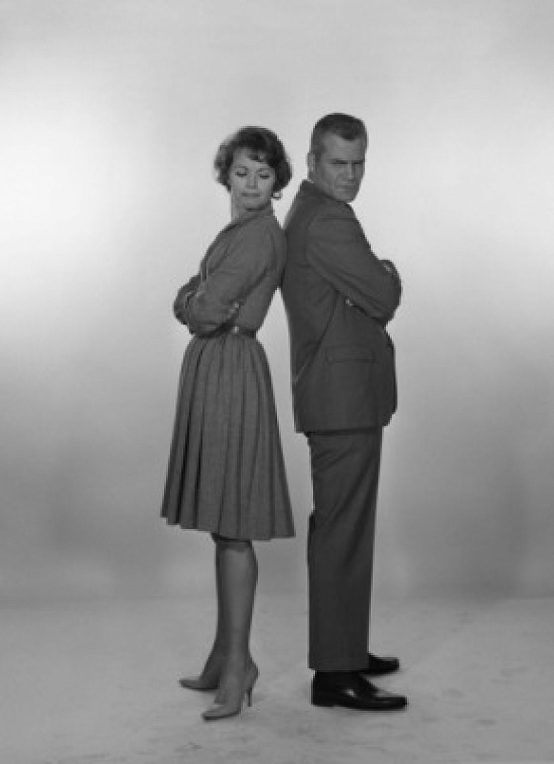 Mid adult couple looking black at each other studio shot Canvas Art - (24 x 36)