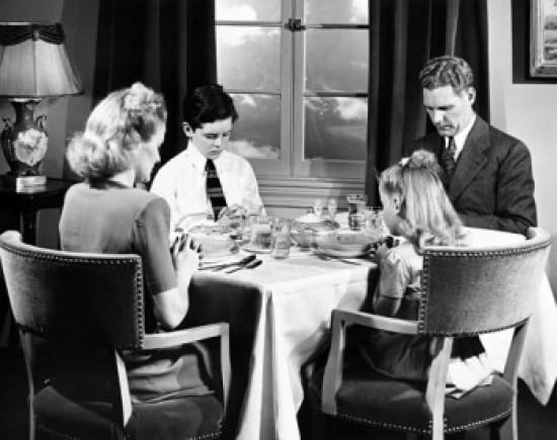 Mid adult couple praying with their children before having breakfast Canvas Art - (18 x 24)