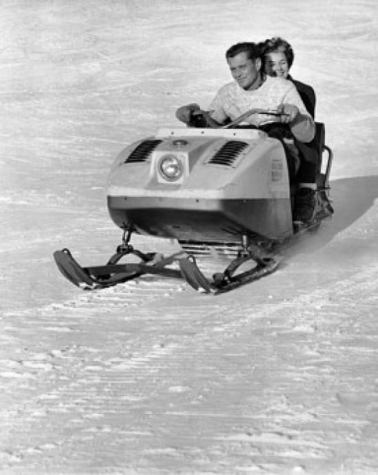 Mid adult couple riding a snowmobile downhill Canvas Art -  (18 x 24)
