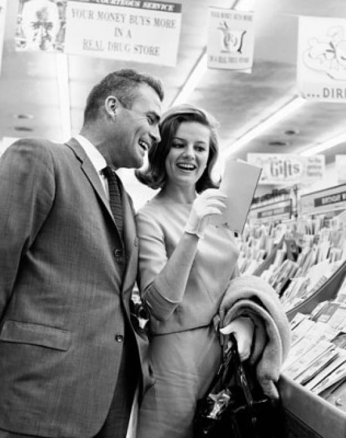 Mid adult couple shopping for greeting cards in a store Canvas Art - (18 x 24)