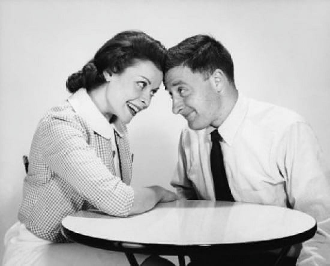 Mid adult couple sitting at a table and smiling Canvas Art - (18 x 24)
