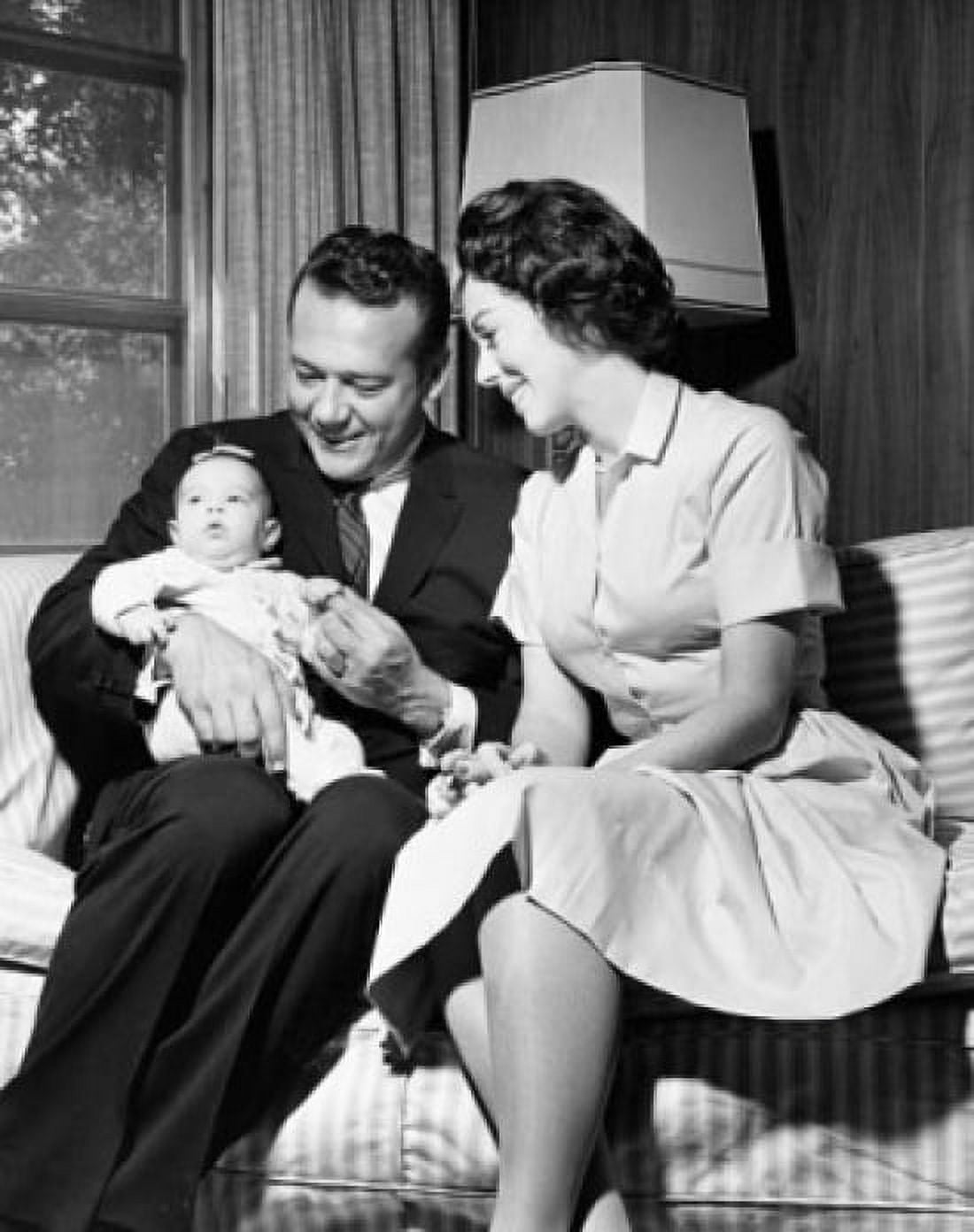 Mid adult couple sitting on couch with baby Canvas Art - (24 x 36)