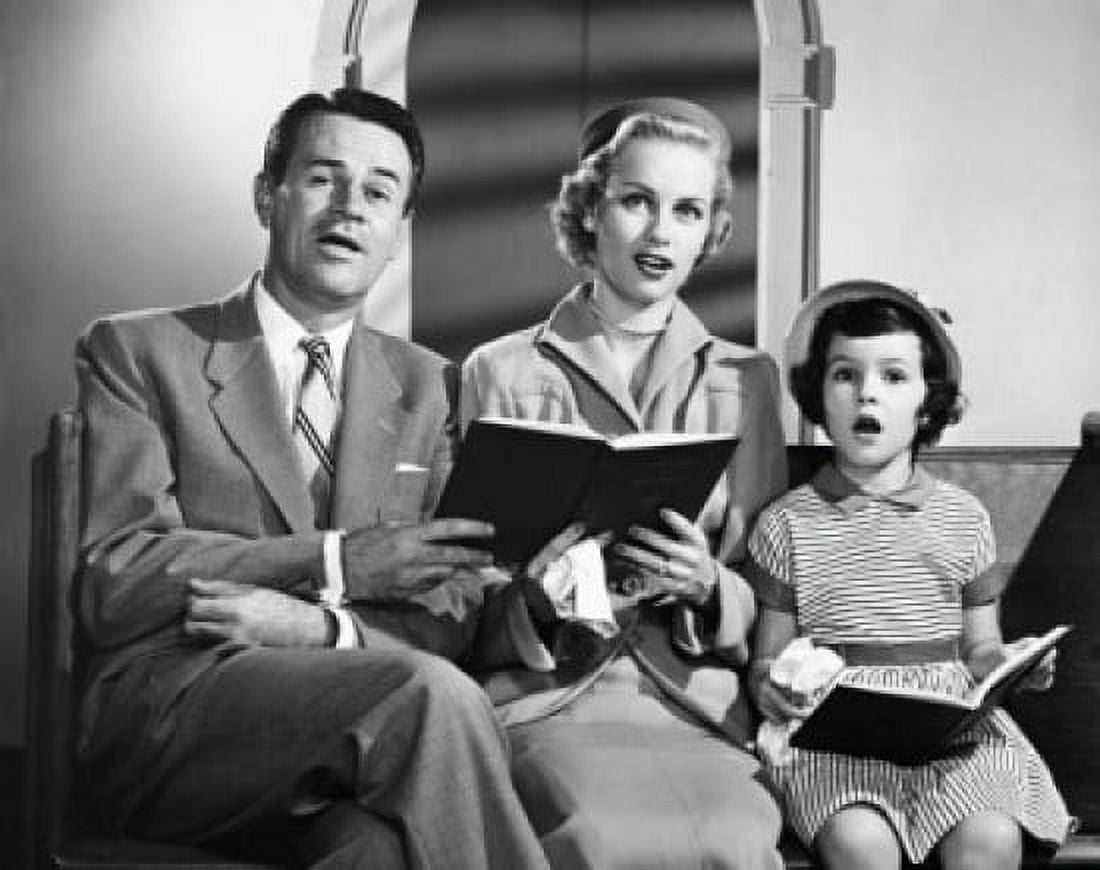 Mid adult couple sitting with their daughter and singing Canvas Art - (24 x 36)