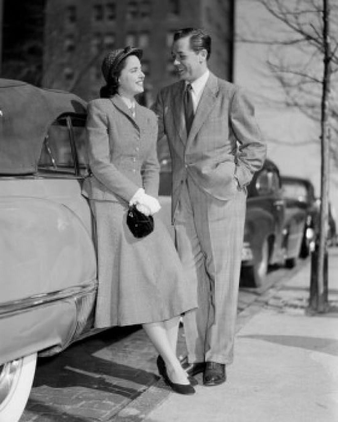 Mid adult couple standing next to car Canvas Art - (24 x 36)