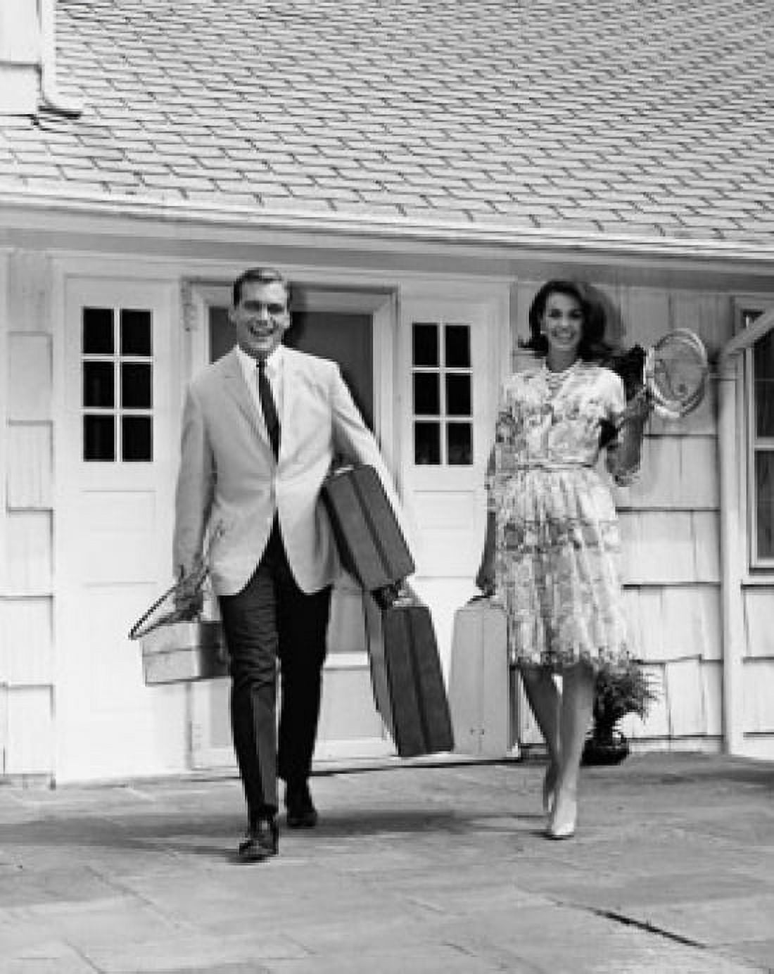 Mid adult couple walking with luggage for vacation Canvas Art - (24 x 36)