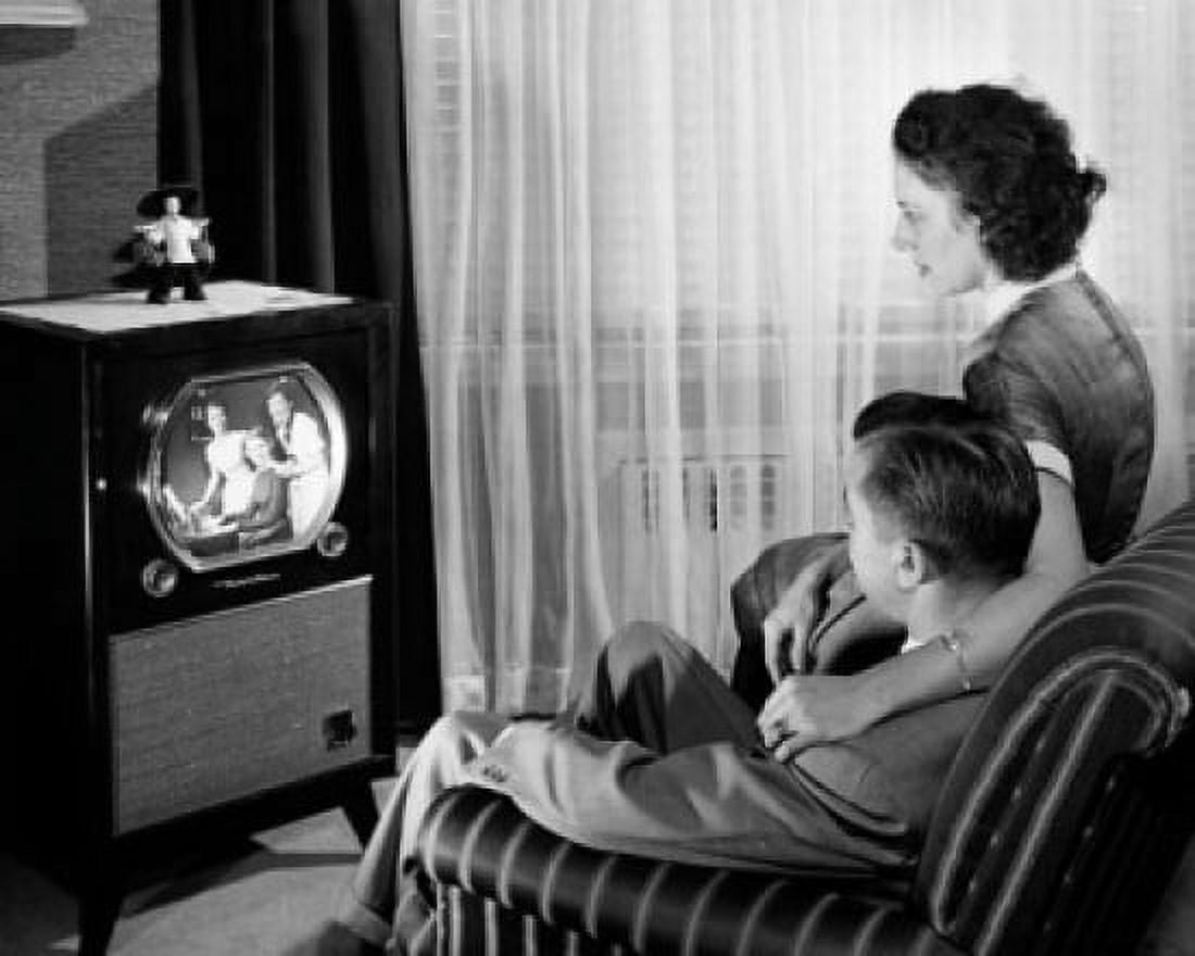 Mid adult couple watching television Canvas Art - (18 x 24)