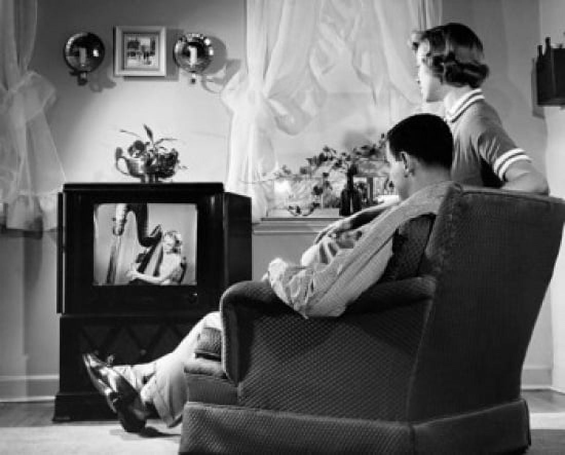 Mid adult couple watching television Canvas Art - (18 x 24)
